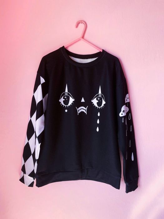 The monochromatic sweatshirt displayed in avant-garde fashion with bold graphic contrast