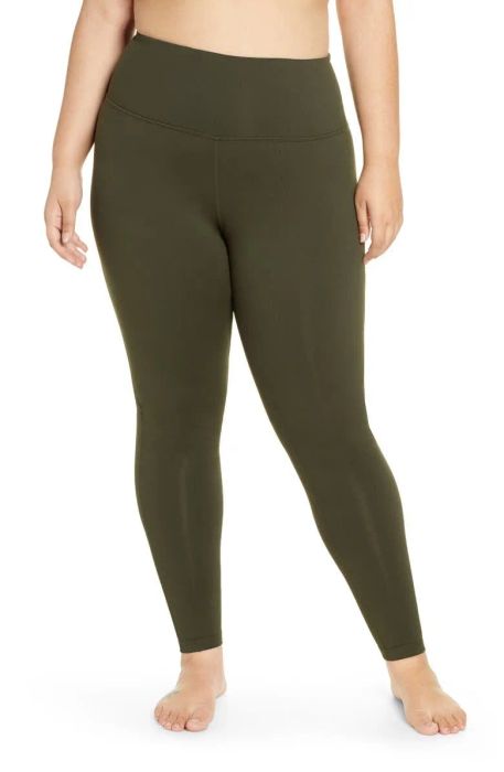 A model wearing olive green high-waisted leggings
