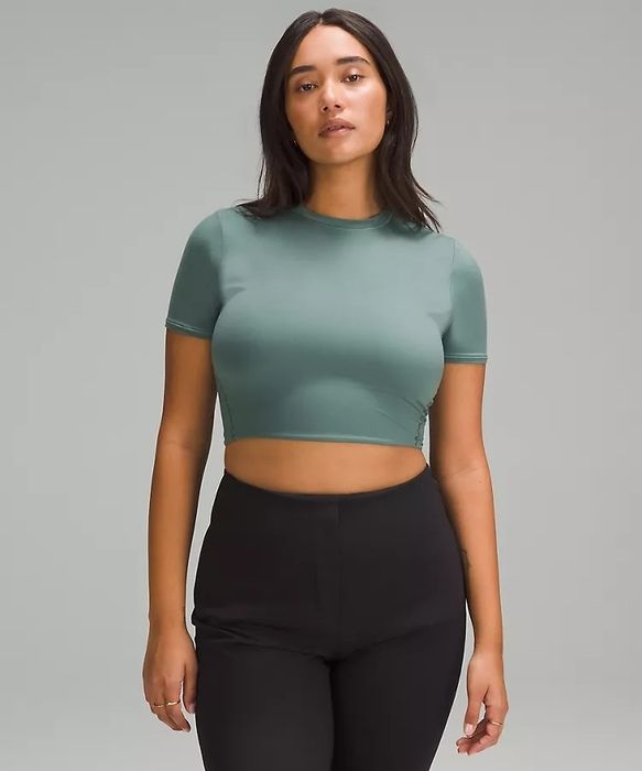 A model wearing the green crop top