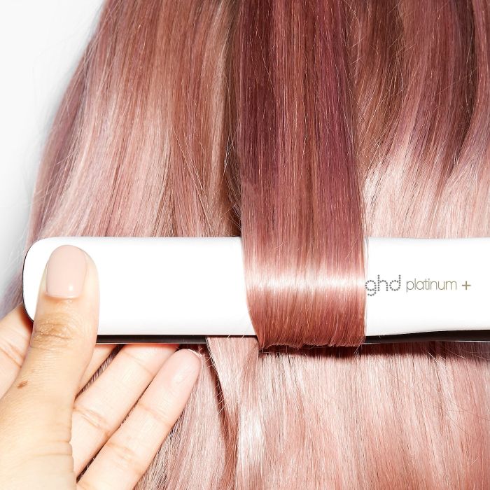 A person’s hair being transformed with the ghd platinum+ flat iron, showcasing smooth, glossy, and perfectly styled results.