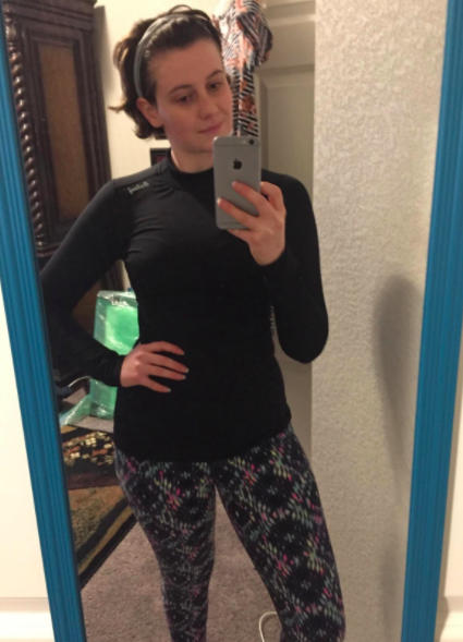 Reviewer wears the same black fleece thermal with patterned leggings before heading out for a run
