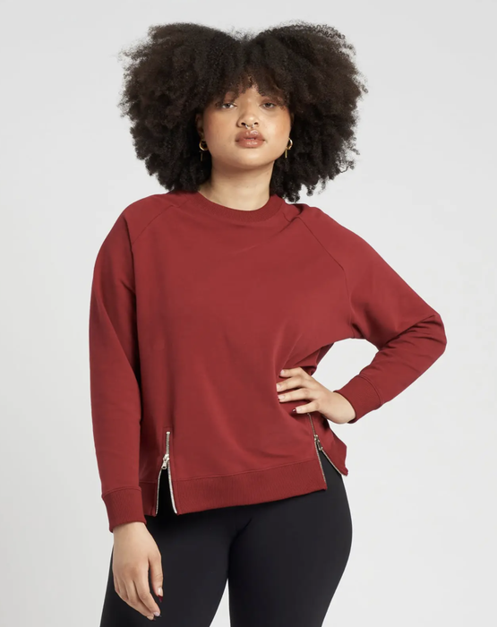 Street-style moment showcasing the bold scarlet hue paired with matte black leggings for monochromatic sophistication