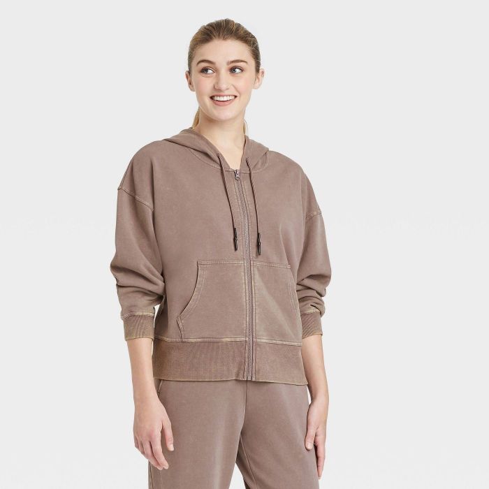 The sweatshirt featured in a soft pink color