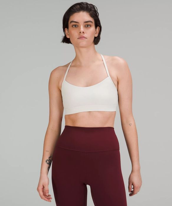 The model showcases the front view of the white bra.