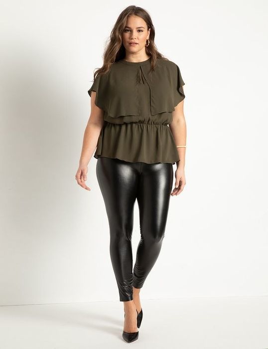 Fashion editor pairs an olive peplum statement piece with glossy onyx leggings