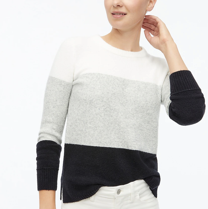 Editorial styling of the graphic charcoal-and-ivory knit masterpiece