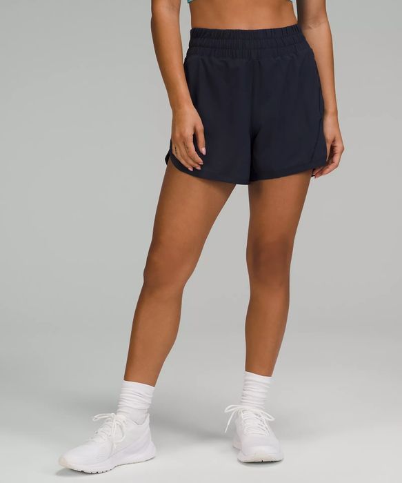 model wearing navy blue running shorts