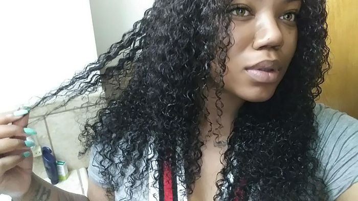 Reviewer showcasing their well-defined curls after applying the gel
