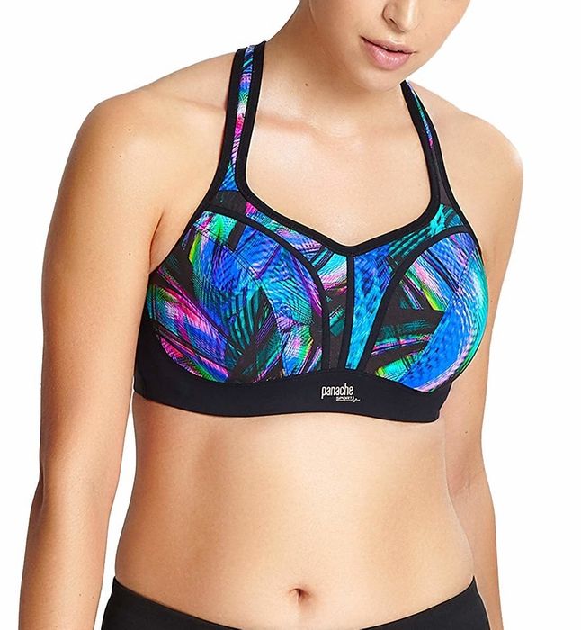 The model is showcasing an underwire sports bra adorned with a vibrant leaf pattern.