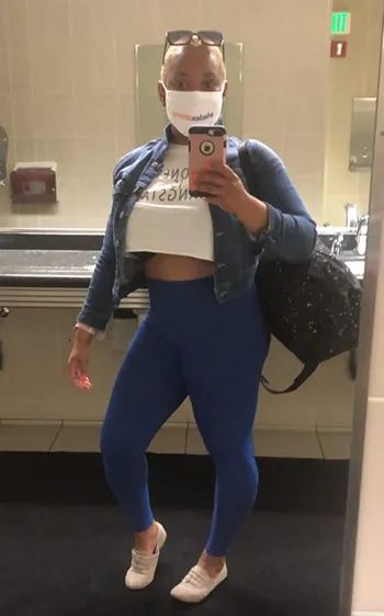 A reviewer wearing blue high-waist leggings