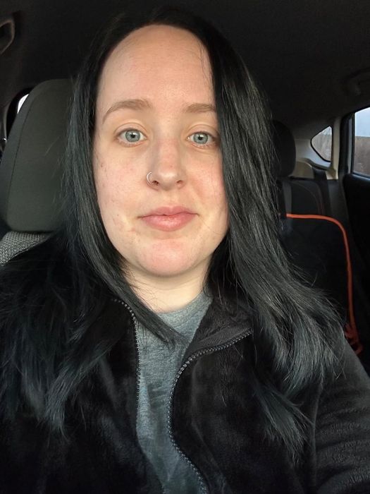 A reviewer's photo showcasing perfectly straight hair achieved after using the flat iron.