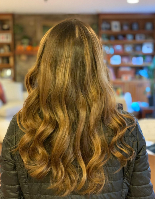 A reviewer's photo showcasing loose curls achieved using the curling wand.