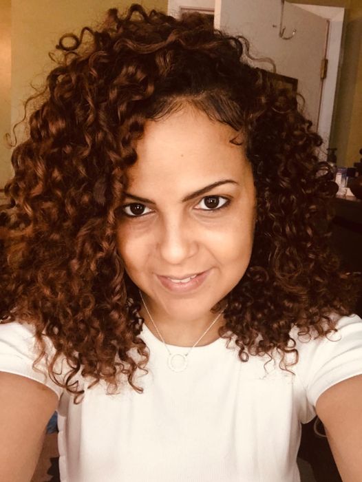 A reviewer's photo showing their hair after using the OGX hair mist.