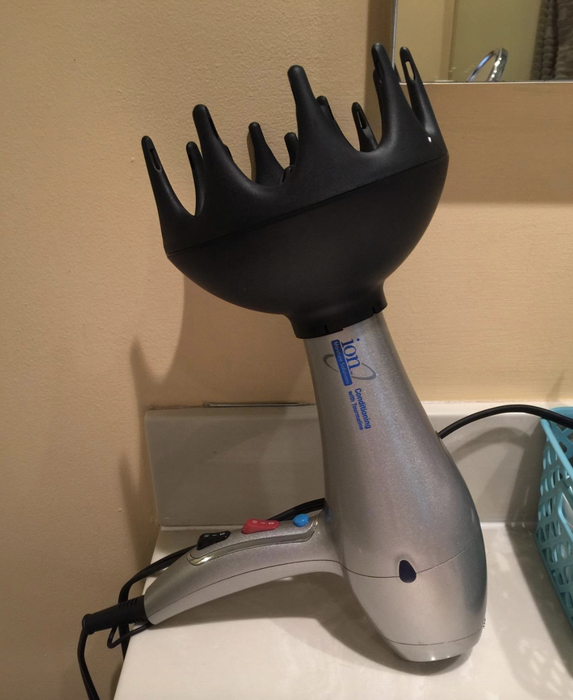 the black diffuser connected to a blow dryer