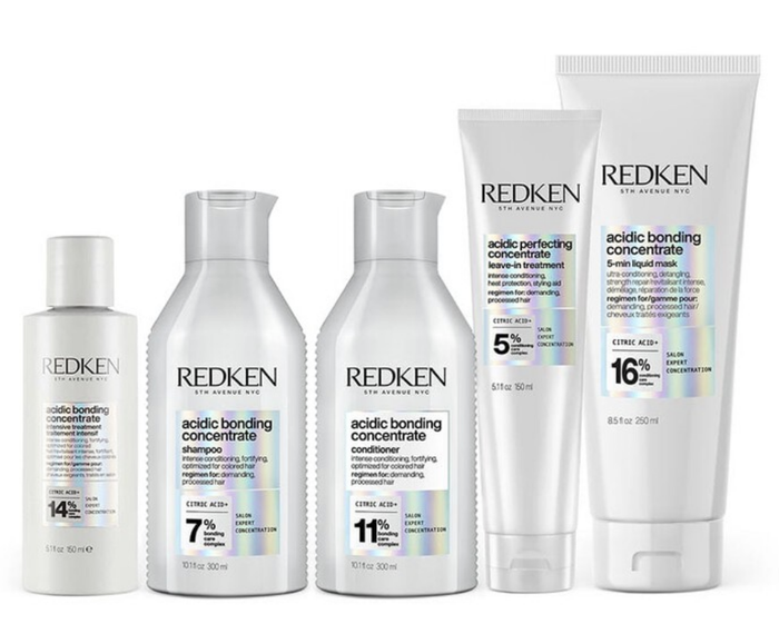 Redken Acidic Bonding Concentrate haircare collection featuring shampoo, conditioners, and leave-in treatment