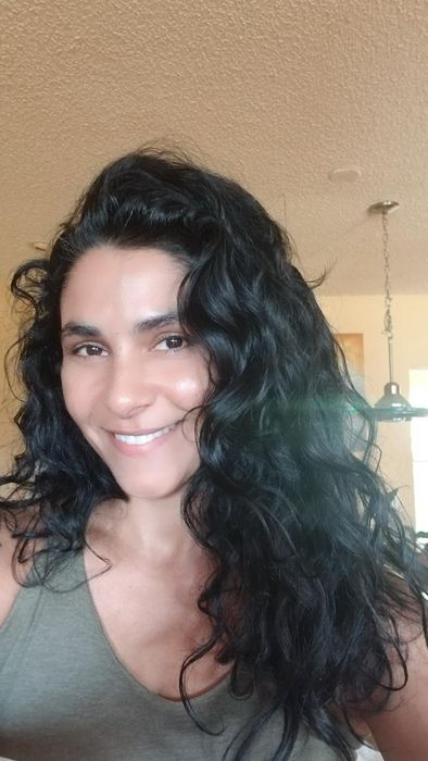 A reviewer's hair transformation after applying Cantu curling cream