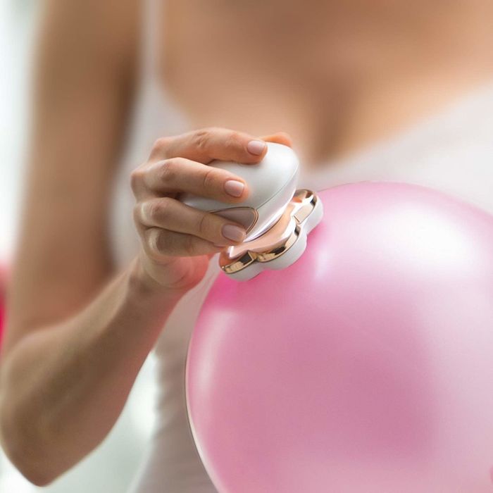 A person gently gliding a razor over a balloon, demonstrating how soft it is on the skin.