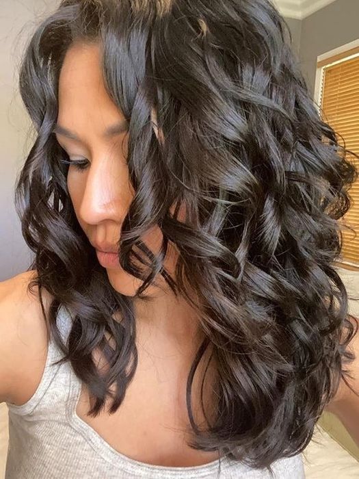 A reviewer with 2B hair flaunting her soft, loose curls