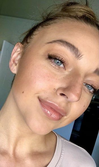 A reviewer showcasing the stone-colored gloss as part of their look.