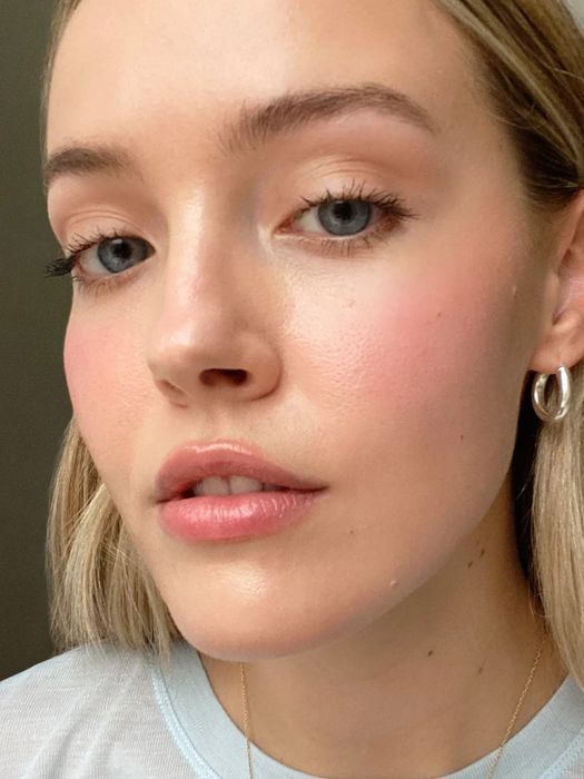 A similar blush applied to a model with lighter skin tones.