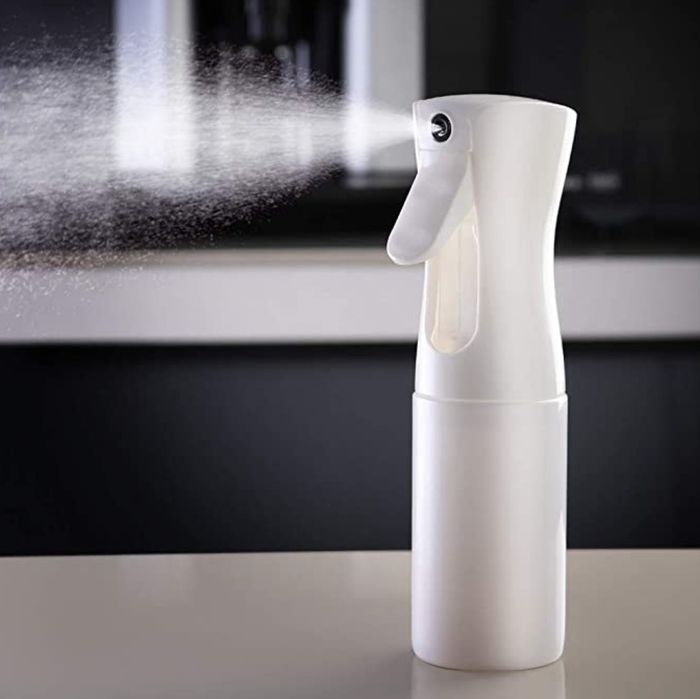A white bottle spraying water