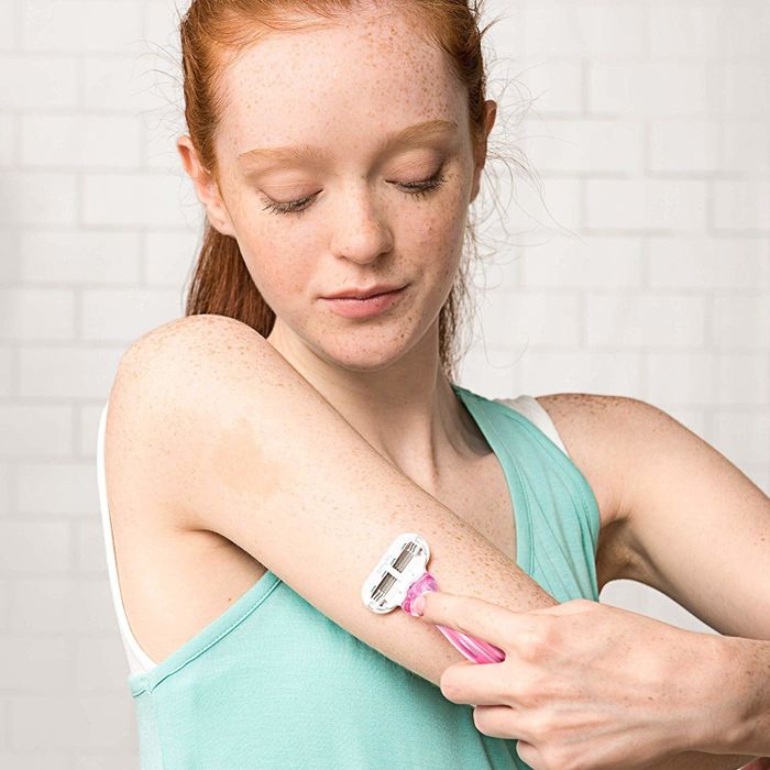 A person using the razor to shave their upper arm.