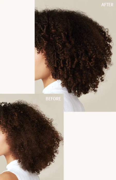 A model with naturally curly, coily hair showing soft, well-defined curls after using the product.