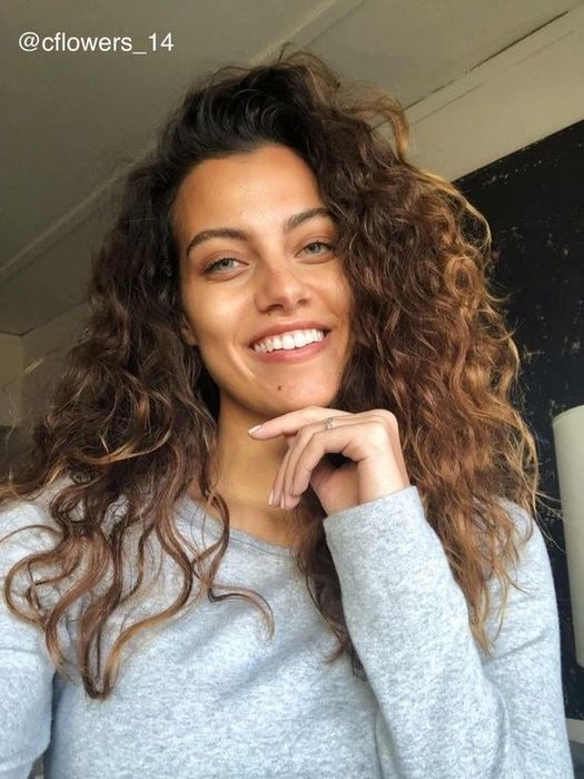 A reviewer with lively, bouncy curls after using the cream