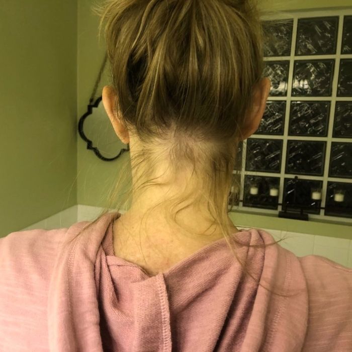 A reviewer demonstrates their messy bun with flyaways at the back.