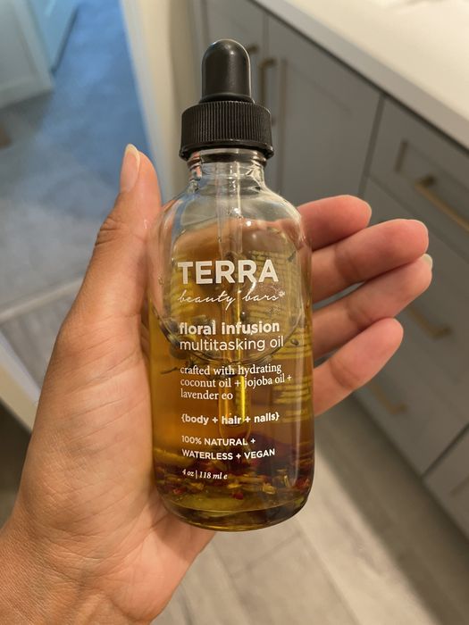 Jasmin is holding the bottle of multitasking oil.