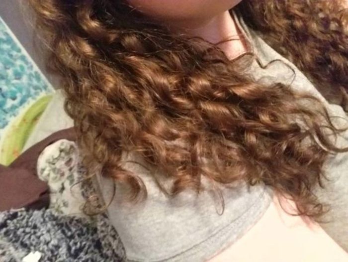 A reviewer displaying the beautifully curled ends of her hair