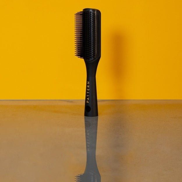 An image of the shower brush against a yellow background.
