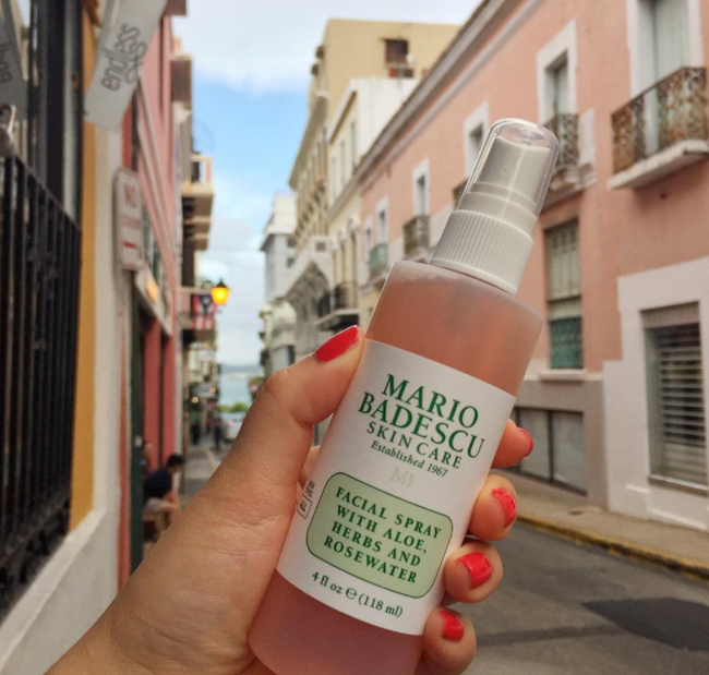A model holding the Mario Badescu Facial Spray