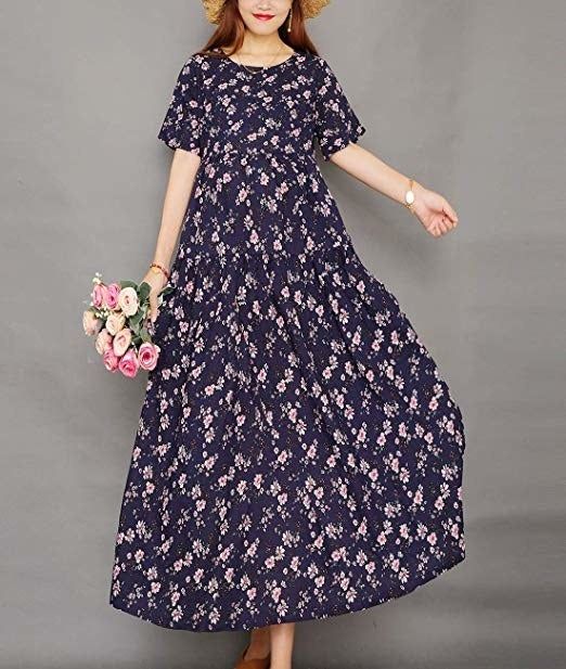 A model rocking the dress in blue adorned with a crisp white pattern.
