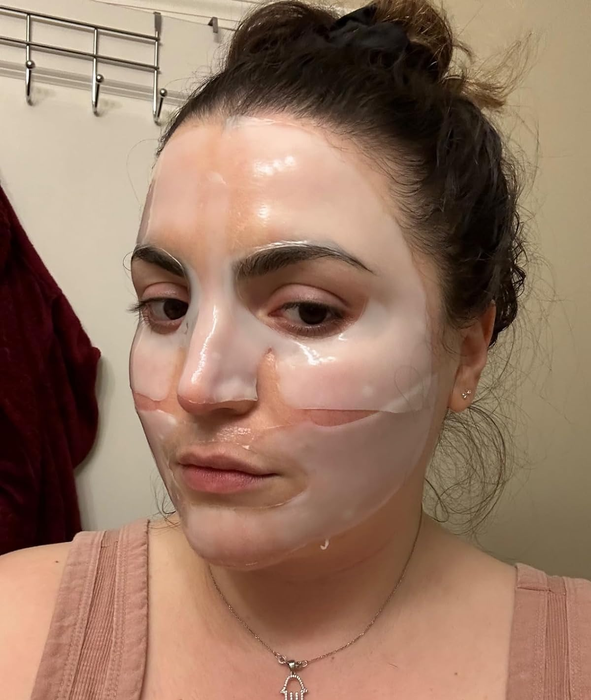A reviewer pictured wearing the face mask