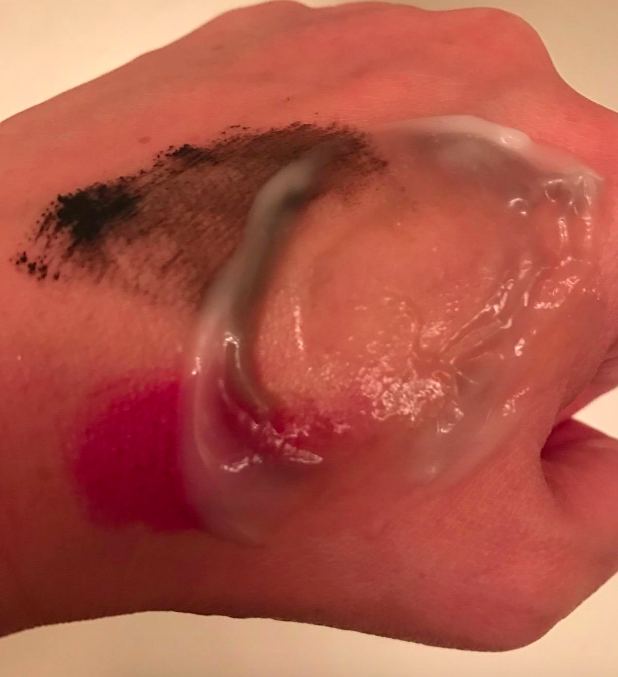 A reviewer removes makeup from their hand, showcasing the product's effectiveness.