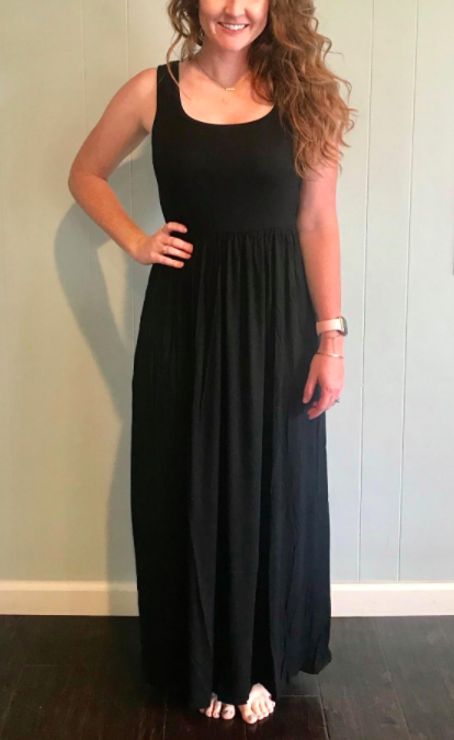 A reviewer wearing the dress, showcasing how the gathered waist creates a bit of shape and definition to the silhouette.