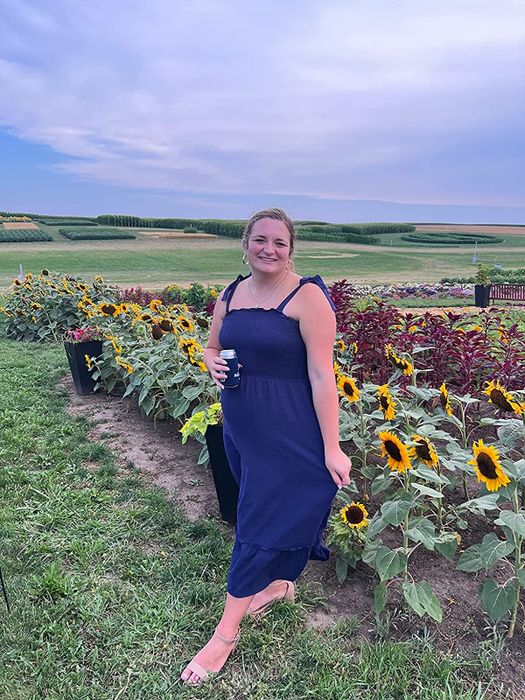 A reviewer rocking the square-neck maxi dress in a deep navy hue.