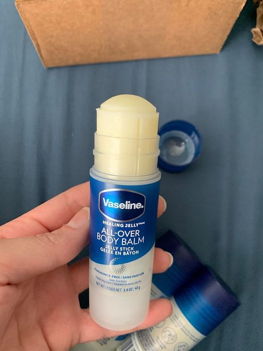 The reviewer showcasing the body balm stick
