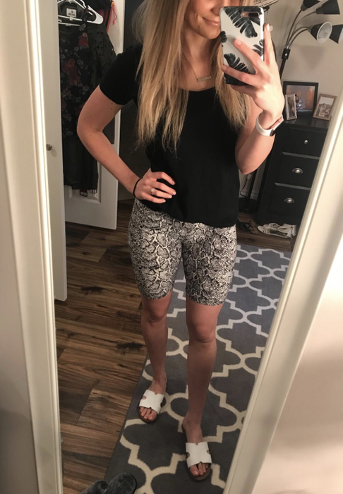 A reviewer wearing black and white paisley bike shorts.
