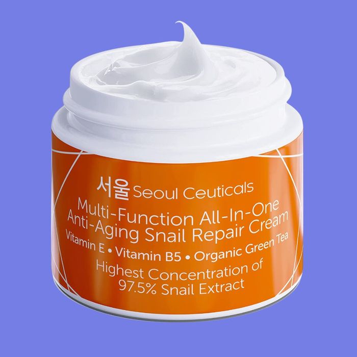 A jar of Seoul Ceuticals Multi-Function All-In-One Anti-Aging Snail Repair Cream, enriched with Vitamin E, B5, Organic Green Tea, and 97.5% Snail Extract.