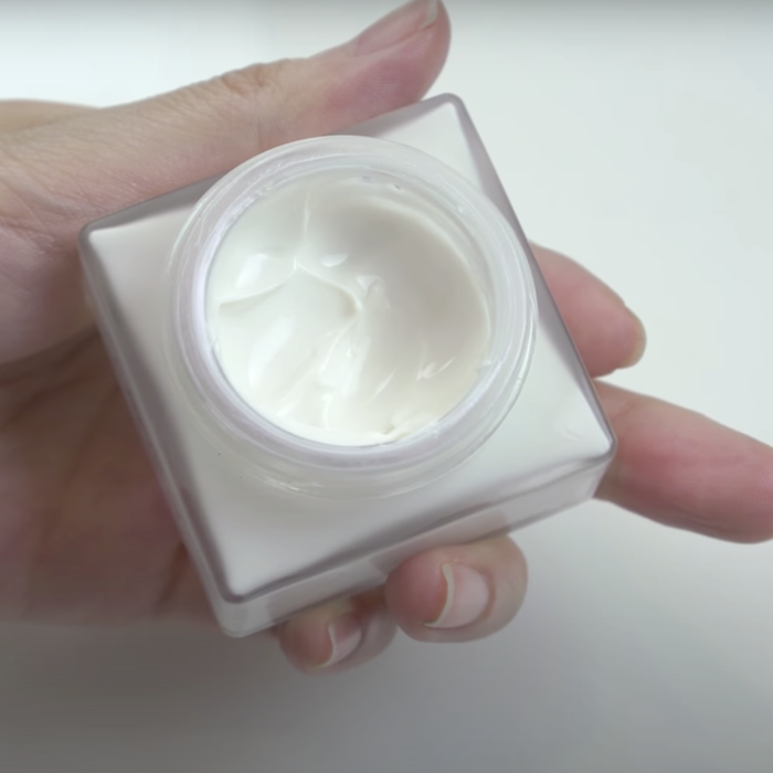 The open jar showing the fluffy texture of the cream.