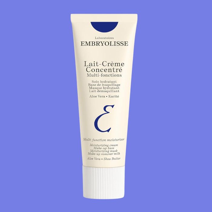 A tube of Embryolisse Lait-Crème Concentré, enriched with Aloe Vera and Shea Butter. The label emphasizes its multifunctional moisturizing properties.