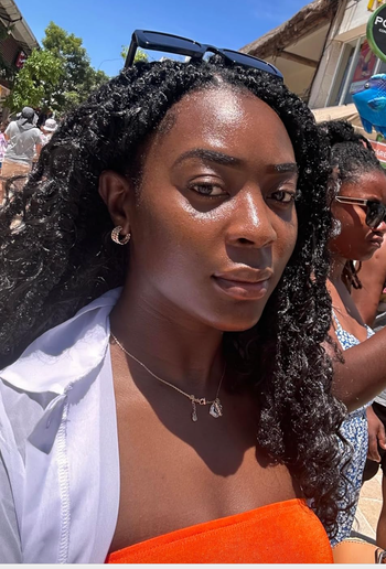Reviewer with a glowing complexion after applying the product