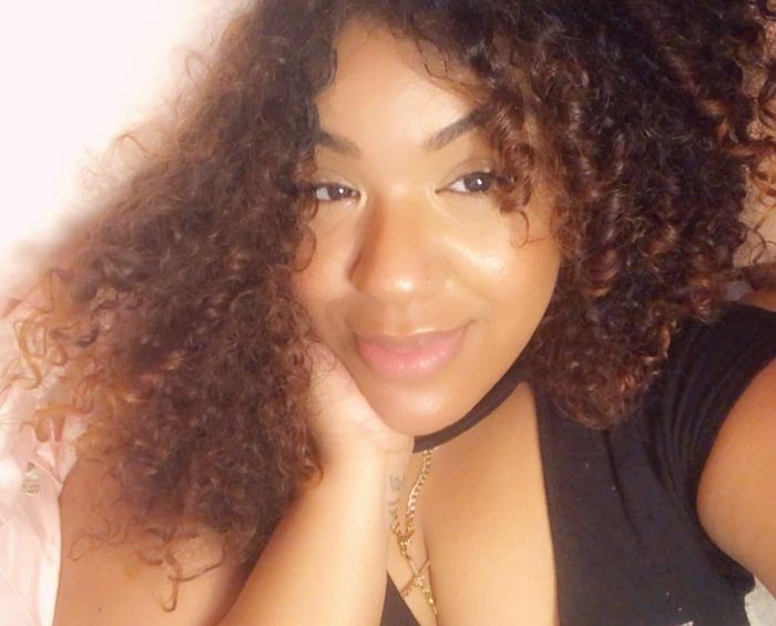 Reviewer applying the cream, radiating a glowing complexion.