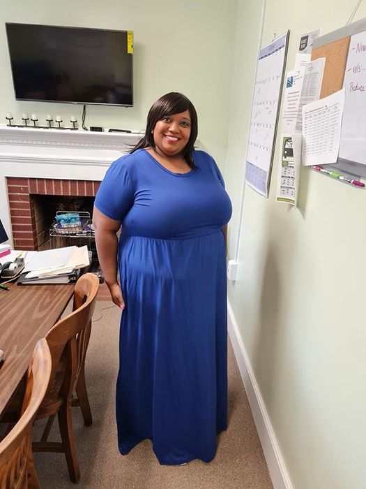 Reviewer sporting a blue dress