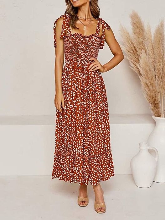 A model is wearing a maxi dress with a playful polka dot print.