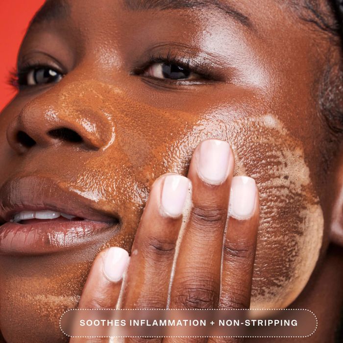 A close-up of someone applying a facial product, with the text 