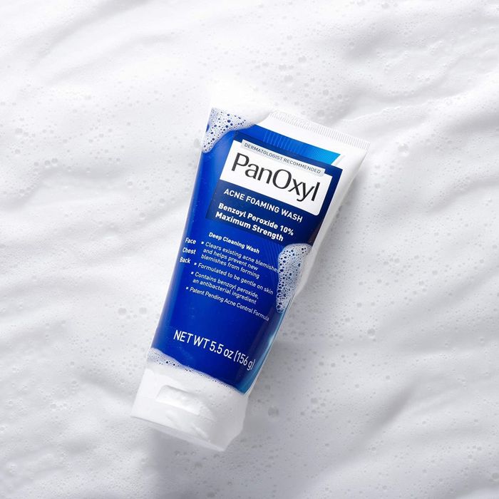 The product is presented in a distinctive blue bottle.