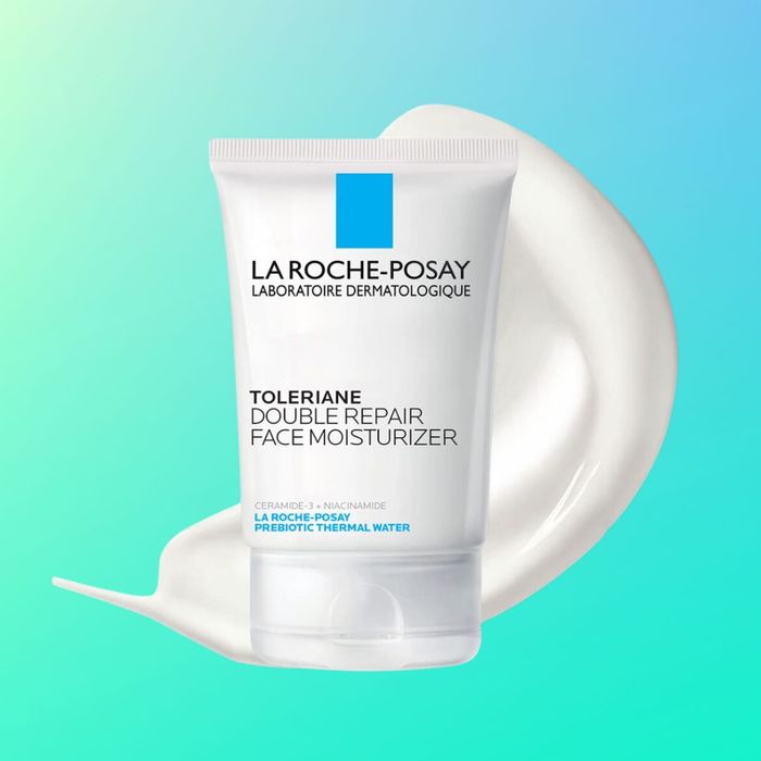A tube of La Roche-Posay Toleriane Double Repair Face Moisturizer placed against a gradient background, with a small amount of the product squeezed out beside it